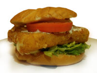 Fried Cheese in a Roll Fried Cheese in a kaiser roll, melted cheese running from the breading, with tomato and lettuce.