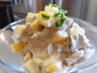 Chicken Salad Bowl of Chicken Salad with creamy dressing, pale chunks, and chopped chives on top.