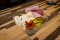 Russian Eggs (Ruské Vejce) Russian Eggs (Ruské Vejce) layered in a martini glass with ham, pickle, roasted pepper, and creamy sauce