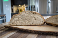 Sliced Czech Rye Bread Sliced Czech Rye Bread showing its dense crumb, on a bark-edged wooden board.