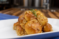 Bobalky with Sauerkraut Plate of Bobalky with Sauerkraut, golden bun pieces topped with shredded sauerkraut and a rosemary sprig.