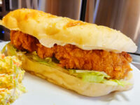 Chicken Tenders Crispy Chicken Tenders fillet in a bread roll with lettuce and mayo, coleslaw served alongside