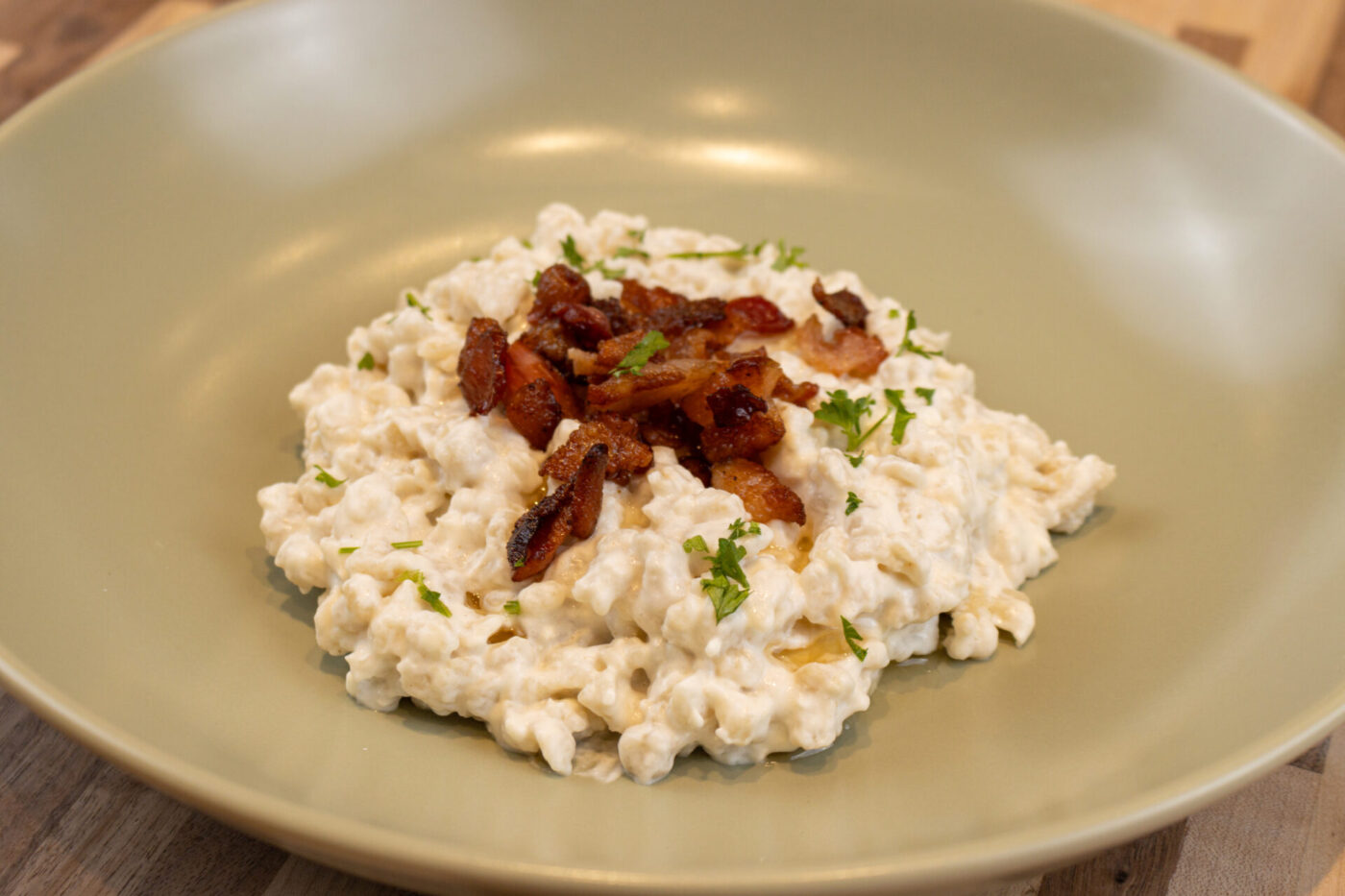 Halušky with Bryndza Cheese Substitution Bowl of Halušky with Bryndza Cheese Substitution topped with crispy bacon and chopped herbs