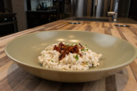 Halušky with Bryndza Cheese Substitution Halušky with Bryndza Cheese Substitution in a sage-green bowl, topped with crispy bits and herbs.