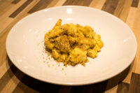 Mac & Cheese A plate of Mac & Cheese with creamy pasta topped in golden herb breadcrumbs.