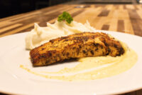 Salmon in Mustard Sauce Seared Salmon in Mustard Sauce fillet on cream sauce with piped mashed potatoes and parsley