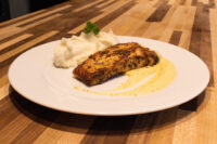 Salmon in Mustard Sauce Seared Salmon in Mustard Sauce fillet plated with mashed potato and pale mustard cream sauce.