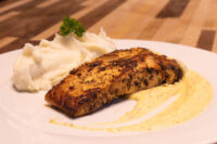 Salmon in Mustard Sauce Seared Salmon in Mustard Sauce fillet on mashed potatoes, drizzled with pale mustard cream sauce.
