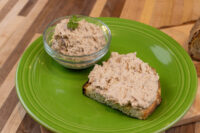 Sardines Dip or Spread Bowl of Sardines Dip or Spread beside a slice of toast spread with the same mixture on a green plate