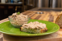 Sardines Dip or Spread Sardines Dip or Spread in a glass bowl beside a toasted slice spread with the same mixture on a green plate