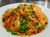 Thai Noodles with Shrimp Plate of Thai Noodles with Shrimp topped with peanuts, sliced chili, scallions, and sesame seeds.