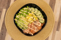 Poke Bowl with Salmon Poke Bowl with Salmon topped with avocado, mango, cucumber, edamame, sesame seeds and creamy drizzle.