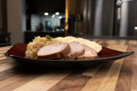 Sliced pork, sauerkraut, and dumpling slices plated for Pork-Sauerkraut-Dumpling (Vepřo-knedlo-zelo)