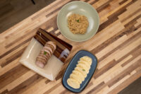 Sliced pork, sauerkraut, and dumpling rounds plated for Pork-Sauerkraut-Dumpling (Vepřo-knedlo-zelo)