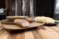 Sliced pork, a bowl of sauerkraut, and sliced dumplings for Pork-Sauerkraut-Dumpling (Vepřo-knedlo-zelo).