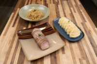 Sliced roast pork, stewed sauerkraut, and dumpling rounds plated for Pork-Sauerkraut-Dumpling (Vepřo-knedlo-zelo)