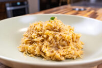 Sauerkraut (Kysane Zelí) Shredded Sauerkraut (Kysané Zelí) in a creamy glaze, garnished with parsley, on a white plate.