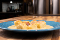 Little Buns with Vanilla Pudding (Buchticky s Krémem) on a blue plate, pale bun pieces in a cream vanilla sauce.