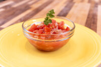 Czech Tomato Salad with Onion Glass bowl of diced tomato and onion Czech Tomato Salad with Onion, topped with cilantro, on a yellow plate
