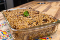 Baked Mushroom Kuba (Houbová Kuba) in a glass dish, topped with parsley and mushroom slices.