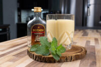 Czech Egg Liqueur – Czech Eggnog Glass of Czech Egg Liqueur – Czech Eggnog garnished with mint, beside a bottle of Božkov Tuzemský rum