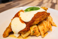 Chicken Parmesan Breaded Chicken Parmesan topped with marinara sauce, melted mozzarella, and basil, served over rigatoni pasta