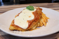 Chicken Parmesan Breaded Chicken Parmesan cutlet with marinara and melted mozzarella over pasta, topped with basil.