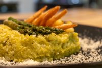 Asparagus Risotto with Shrimp Plated Asparagus Risotto with Shrimp topped with asparagus spears, shrimp tails, and grated cheese.