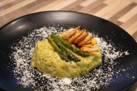 Asparagus Risotto with Shrimp Plated Asparagus Risotto with Shrimp topped with grilled shrimp and asparagus spears, dusted with parmesan.