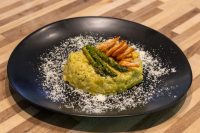 Asparagus Risotto with Shrimp Plated Asparagus Risotto with Shrimp: yellow risotto topped with asparagus spears and shrimp on a black dish.