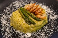 Asparagus Risotto with Shrimp Plated Asparagus Risotto with Shrimp topped with grilled shrimp and asparagus spears, dusted with parmesan.
