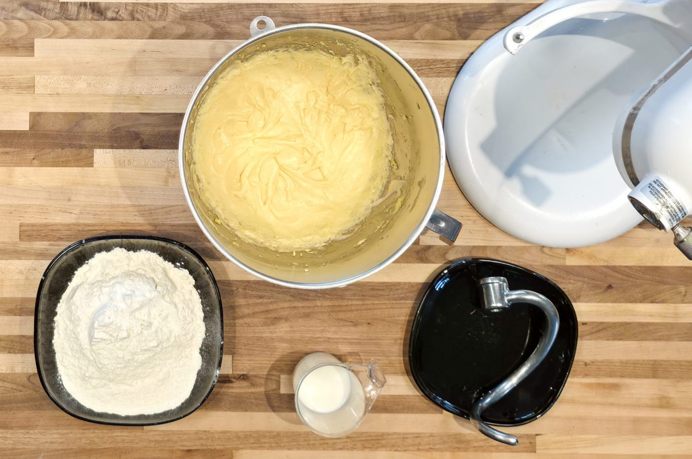 Whipped batter in mixer bowl beside flour and milk, prepping dough for Frgal Kolach with Pear Filling