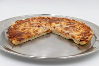 60 min. Pan Pizza Thick-crust 60 min. Pan Pizza with melted cheese, sliced into wedges, on a round metal pan.