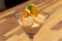 Shrimp Cocktail in a martini glass with creamy sauce, lemon twist, and parsley garnish