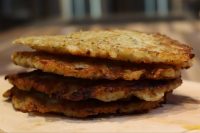 Bramboraky Stack Stack of four crispy golden Potato Pancakes Bramboraky on a wooden board.