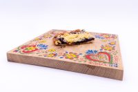 Sheet Kolach with Streusel A slice of Sheet Kolach with Streusel showing dark berry filling and crumble topping on a painted wooden board.