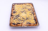 Sheet Kolach with Streusel Sheet Kolach with Streusel on a metal baking sheet, golden crumb topping with dark berry filling showing through.