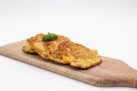 Side Potato Pancakes Bramboráčky Four crispy Side Potato Pancakes Bramboráčky on a wooden board with parsley garnish.