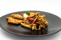 Slovak Meat Sauté Mäsové Soté with peppers and onions, sour cream and parsley, served with potato patties