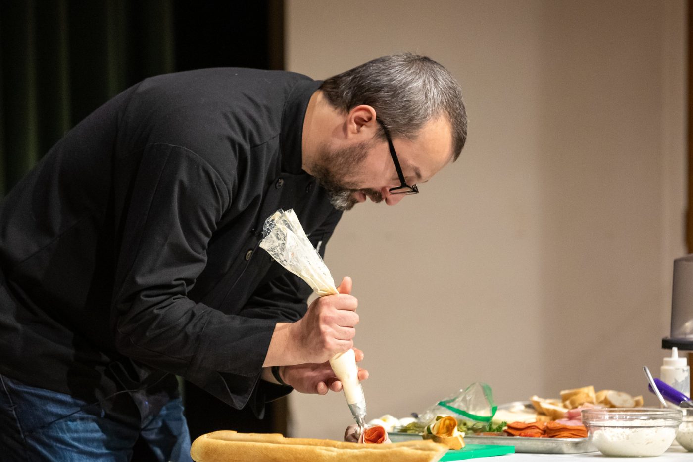 Detail shot of Tom Slepicka (aka Tom the Chef) preparing the food during presentation at Missouri Southern State University in Joplin during Czech Semester 2022.
